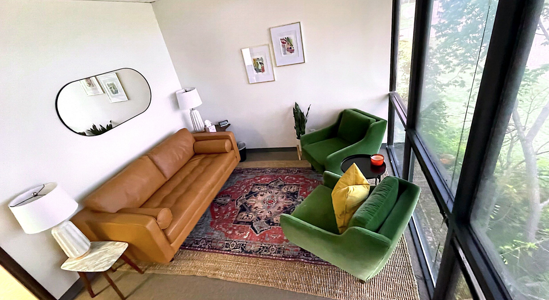 Bright Fort Worth Therapy Associates therapy office with an arched window, green chairs, and framed art prints on the wall